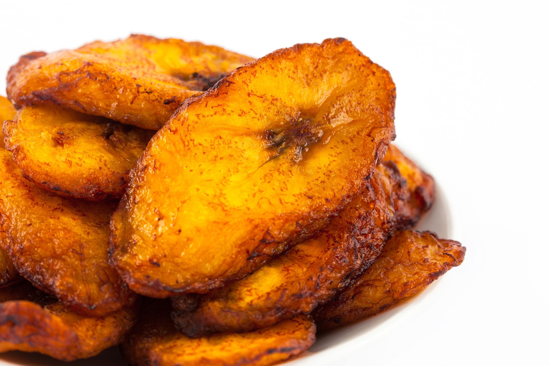 Deep fried ripe plantain slices isolated in white background