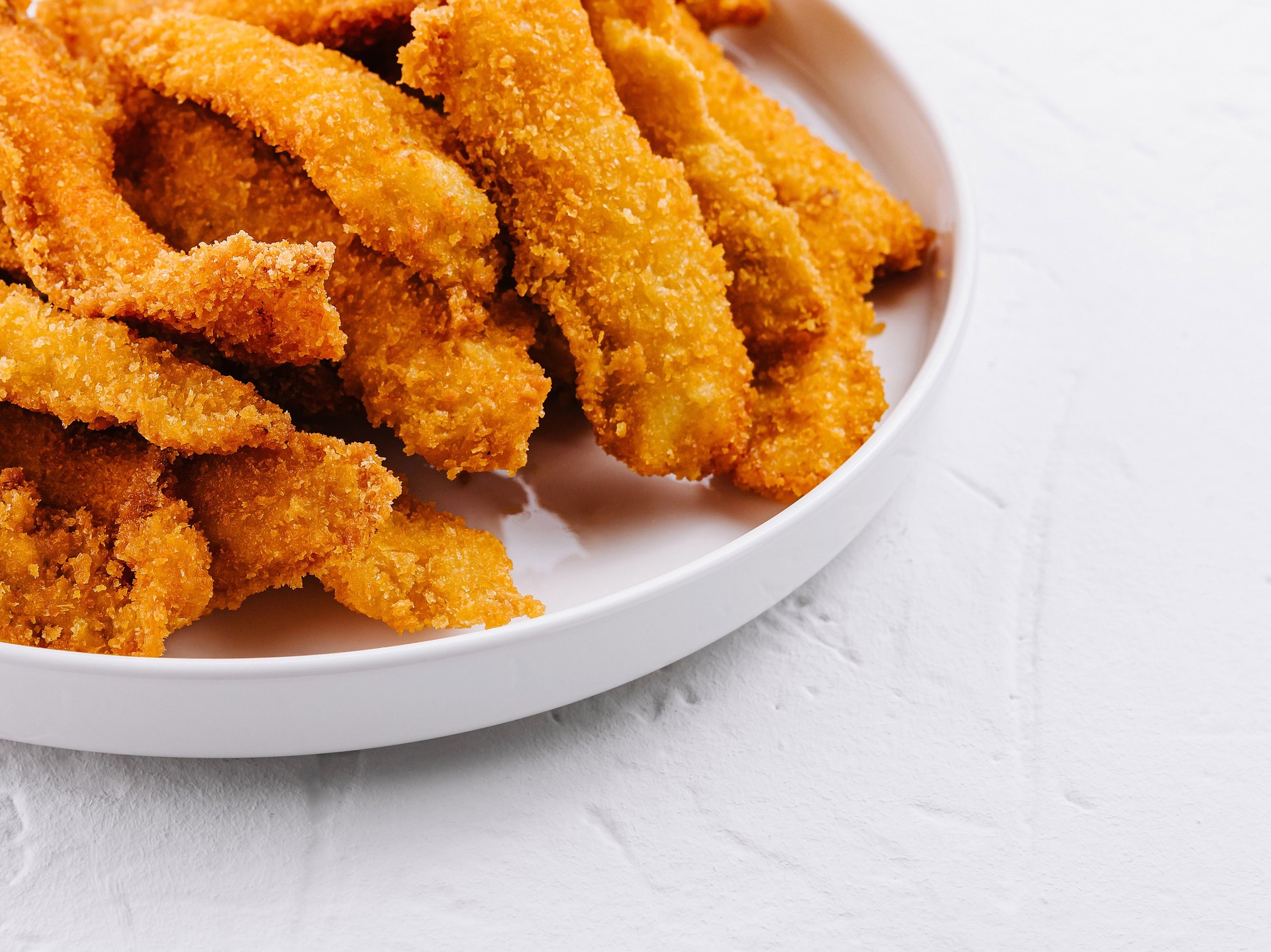 Crispy breaded chicken strips with dipping sauce