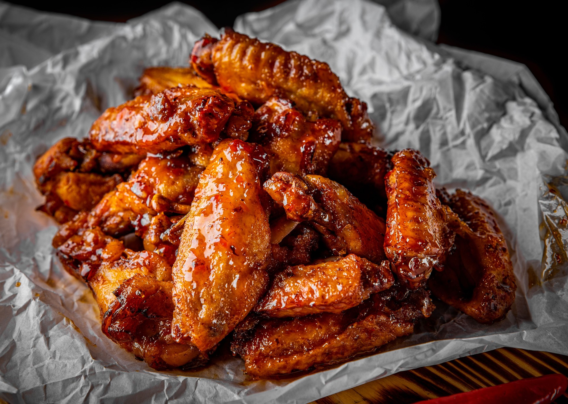 fried chicken wings with sweet chili sauce on white paper