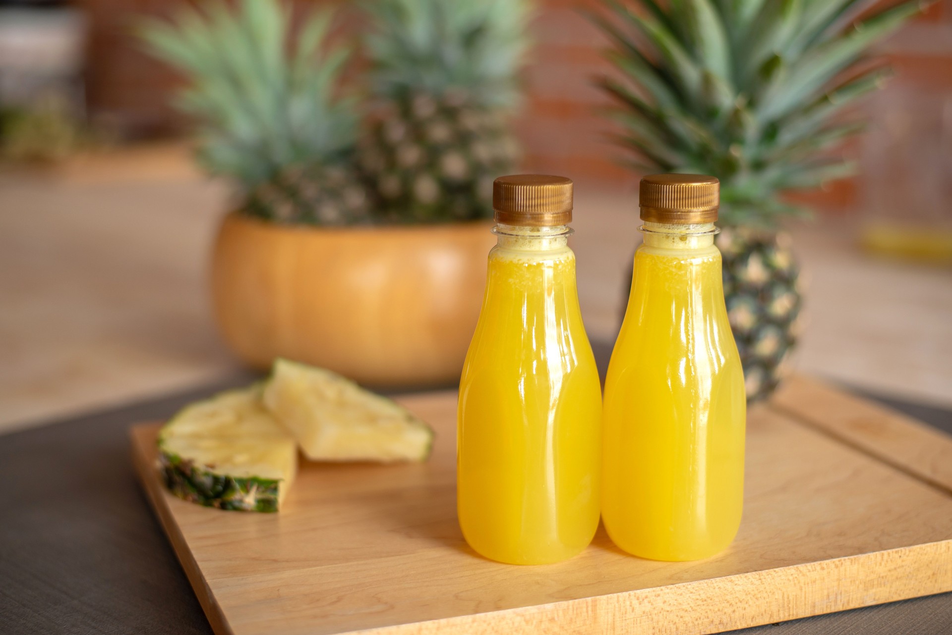 Bottle of of pineapple on the wooden cutting board. Pineapple is a tropical fruit healthy and very juicy.